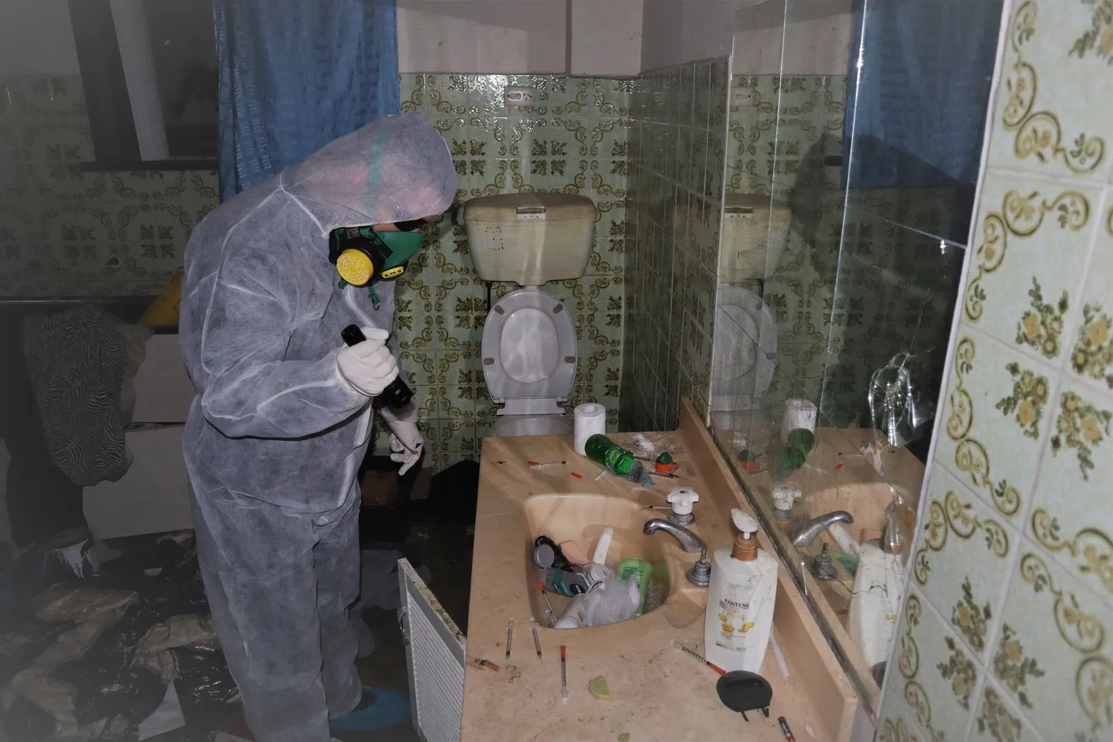 Licensed inspector in protective equipment conducting a thorough property inspection