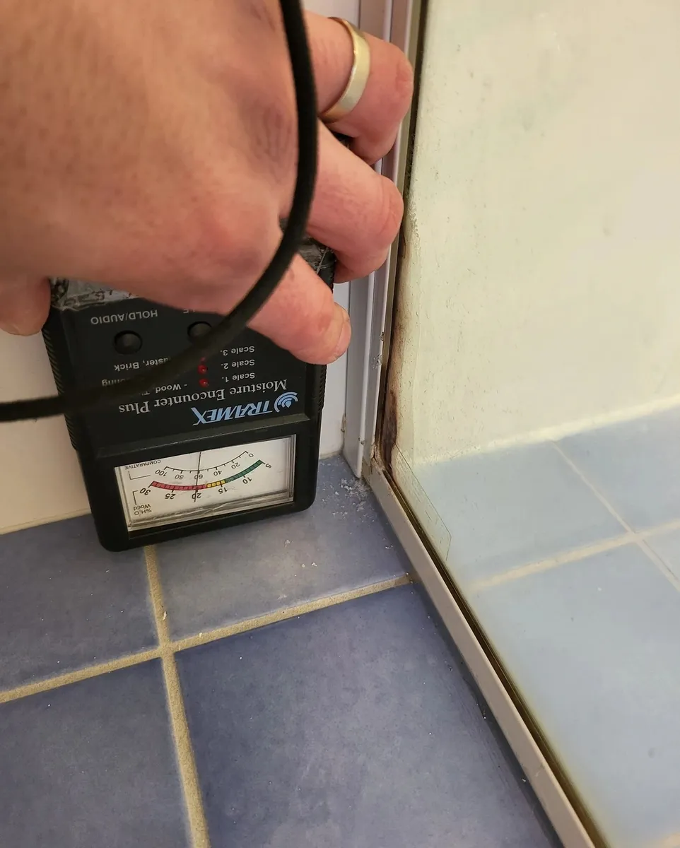 Moisture meter reading taken on tiling during a building inspection